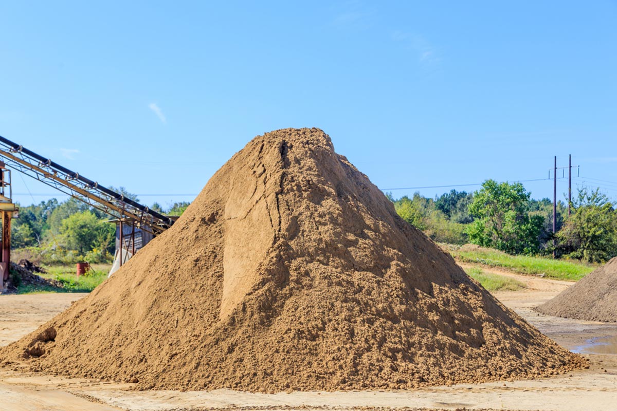 homeguide-dump-truck-load-of-screened-sand-in-pile.jpeg